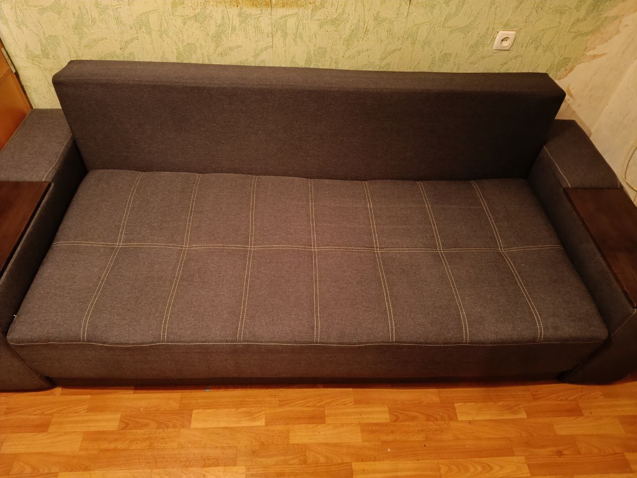 Чистый коричневый диван после удаления пятен и пыли мастерами